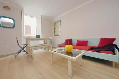 a living room with a red couch and a table at Monti Studio in Rome
