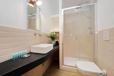 a bathroom with a toilet and a sink and a shower at Monti Studio in Rome