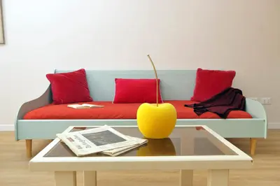 a living room with a couch with red pillows and a table at Monti Studio in Rome