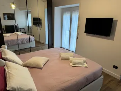a bedroom with a bed with two towels on it at Civico Nove al Colosseo in Rome