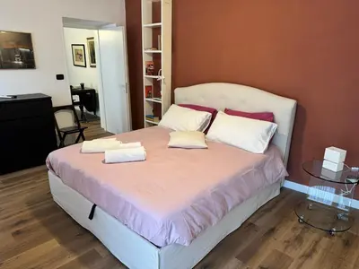a bedroom with a bed with two pillows on it at Civico Nove al Colosseo in Rome