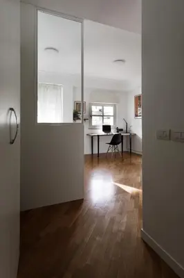 an open room with a desk and a table with a window at Studio Margherita in Rome