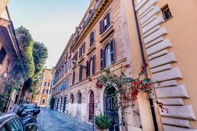 an alley in an old building with flowers on it at Trastevere House 24 in Rome
