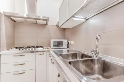 a kitchen with a sink and a microwave at Trastevere House 24 in Rome