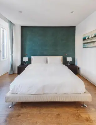 a bedroom with a large white bed with two night stands at The Place Giuliana in Rome