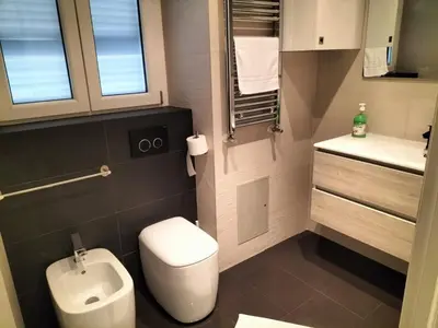 a small bathroom with a toilet and a sink at OLD BAKERY TWO BED ROOM APARTMENT in Rome