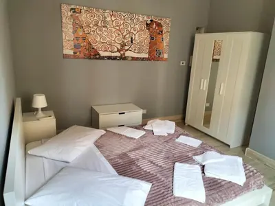 a bedroom with two beds and a painting on the wall at OLD BAKERY TWO BED ROOM APARTMENT in Rome