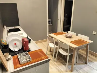 a kitchen with a table with chairs and a sink at OLD BAKERY TWO BED ROOM APARTMENT in Rome