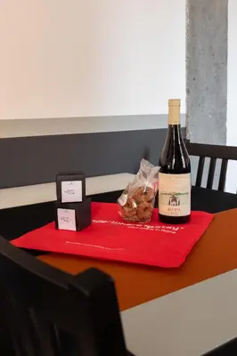 a bottle of wine sitting on top of a table at Trastevere Charming Rosa Apartment in Rome