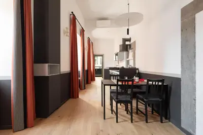 a dining room with a black table and black chairs at Trastevere Charming Rosa Apartment in Rome