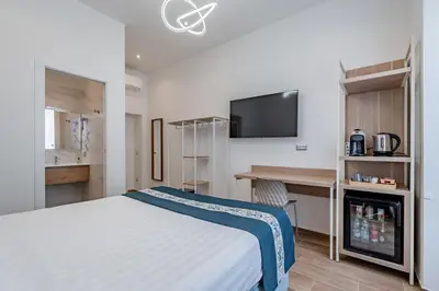 a bedroom with a bed and a blue wall at Belltower Elegans Guest House in Rome