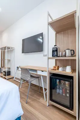 a bedroom with a bed and a desk and a couch at Belltower Elegans Guest House in Rome