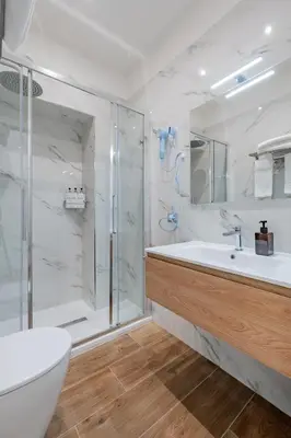 a bedroom with a bed and a bathroom with a sink at Belltower Elegans Guest House in Rome