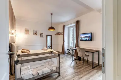 a bedroom with two bunk beds and a table at Kira Luxury Apartment with terrace in Rome