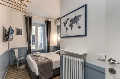 a small bedroom with a bed and a radiator at Kira Luxury Apartment with terrace in Rome