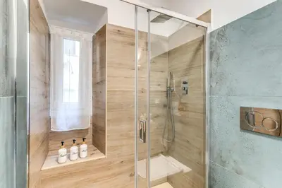 a shower with a glass door in a bathroom at Kira Luxury Apartment with terrace in Rome