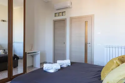 a bedroom with a bed with towels on it at A due passi dal Colosseo in Rome