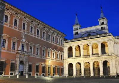 two buildings with a clock tower in the background at A due passi dal Colosseo in Rome