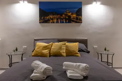 a bedroom with a bed with two towels on it at A due passi dal Colosseo in Rome