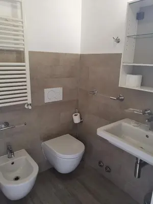 a bathroom with a white toilet and a sink at I love Colosseo in Rome