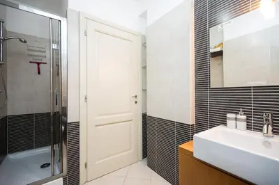 a bathroom with a sink and a shower and a mirror at Boutique Domus River Terrace in Rome