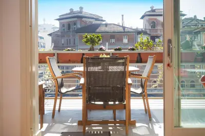a table and chairs on a balcony with a view at Boutique Domus River Terrace in Rome
