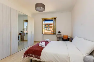 a bedroom with a bed with two towels on it at Italia Room vicino Stazione Termini in Rome