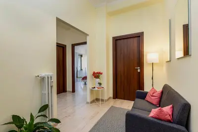 a living room with a couch and a door at Italia Room vicino Stazione Termini in Rome
