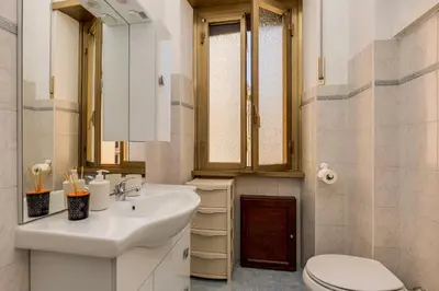 a white bathroom with a sink and a toilet at Italia Room vicino Stazione Termini in Rome