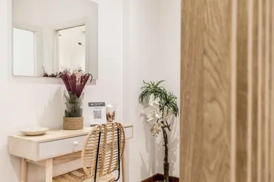 a room with a table and a chair and a mirror at Sweethome Marconi in Rome