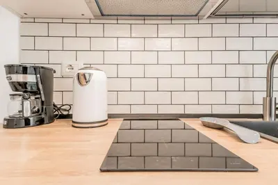 a kitchen counter with a coffee maker on a counter at Sweethome Marconi in Rome