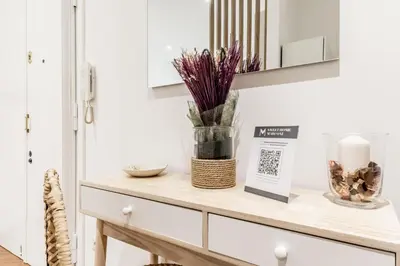 a shelf with a candle and flowers on it in a kitchen at Sweethome Marconi in Rome