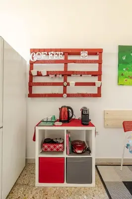a small white cabinet in a room at Aura Home Grazioso Appartamento a Pochi Passi dalla Metro A e C in Rome