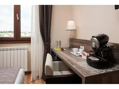a hotel room with a desk with a coffee machine on it at Window On Rome in Rome