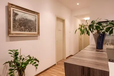 a hallway with plants and a painting on the wall at Window On Rome in Rome