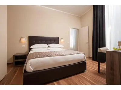 a bedroom with a large bed with white pillows at Window On Rome in Rome