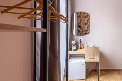 a bedroom with a bed and a wall with a leafy wallpaper at Affittacamere Casalí in Rome