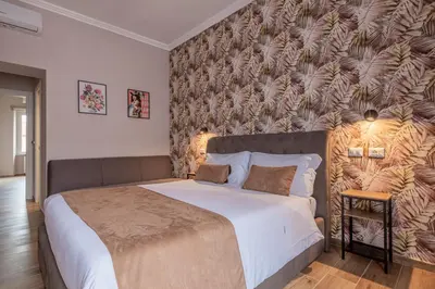 a bedroom with a large bed with a wall at Affittacamere Casalí in Rome
