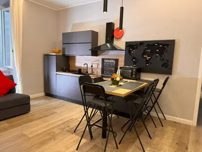 a kitchen and dining room with a table and chairs at GetRoma apartment Vatican Museum in Rome