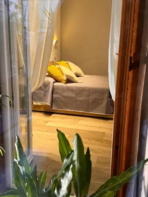 a mirror reflection of a bed in a bedroom at GetRoma apartment Vatican Museum in Rome