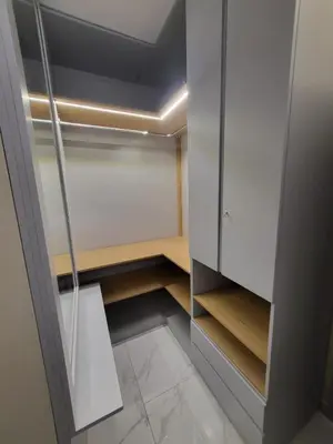 a walk in closet with white cabinets and a glass door at Aurelia Boutique Apartment in Rome