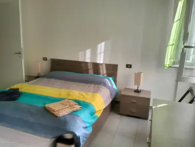 a bedroom with a bed and a table with a lamp at Appartamento Monteverde in Rome