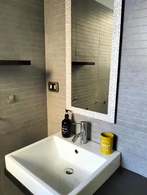 a white sink in a bathroom with a mirror at Appartamento Monteverde in Rome
