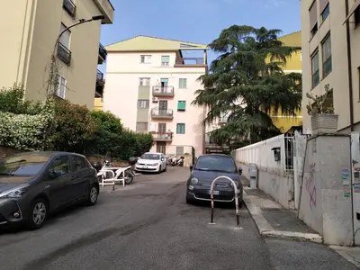 a street with cars parked on the side of the road at Appartamento Monteverde in Rome