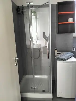 a shower with a glass door in a bathroom at Appartamento Monteverde in Rome