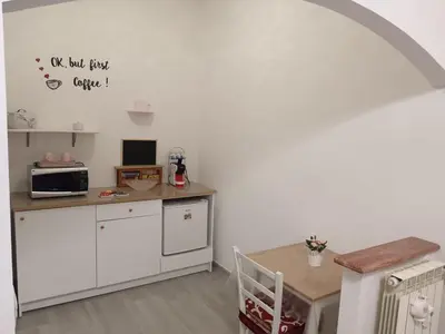 a small kitchen with a table and a microwave at B&B VIKTORIA in Rome