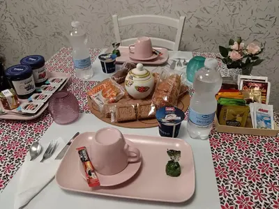a table with a pink tray of food and bottles of water at B&B VIKTORIA in Rome