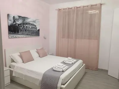 a white bedroom with a bed and a shower at B&B VIKTORIA in Rome