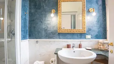 a bathroom with a sink and a mirror at EasyTopStay - Colonna Guest House in Rome