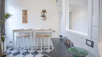 a small bar with stools in a room at EasyTopStay - Colonna Guest House in Rome